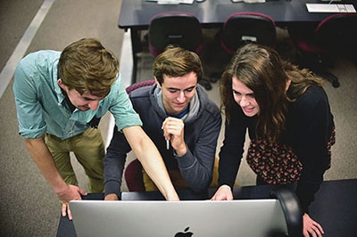 Three Students Looking at Computer