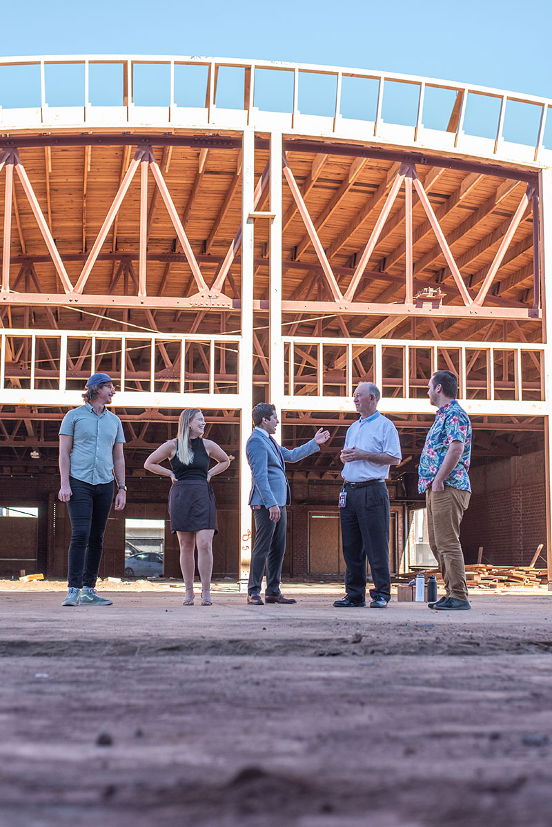 Prof. Max Hulburt, Eleazar Palma, President Derry Connolly, Prof. Katelyn Slater, and Prof. Joe Connolly visit the construction site to see the latest work.