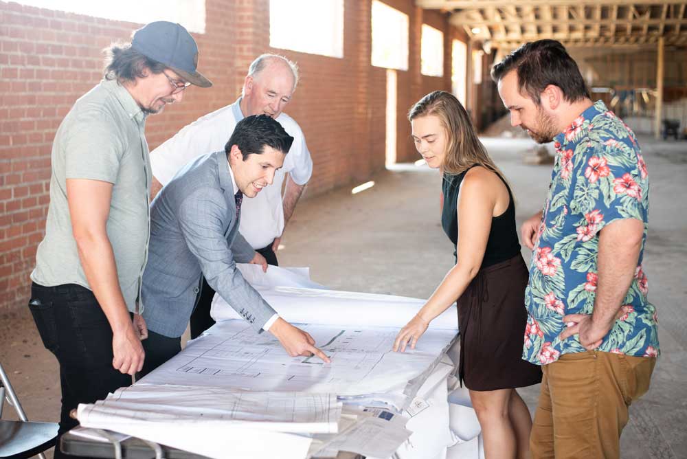 Prof. Max Hulburt, Eleazar Palma, President Derry Connolly, Prof. Katelyn Slater, and Prof. Joe Connolly visit the construction site to see the latest work