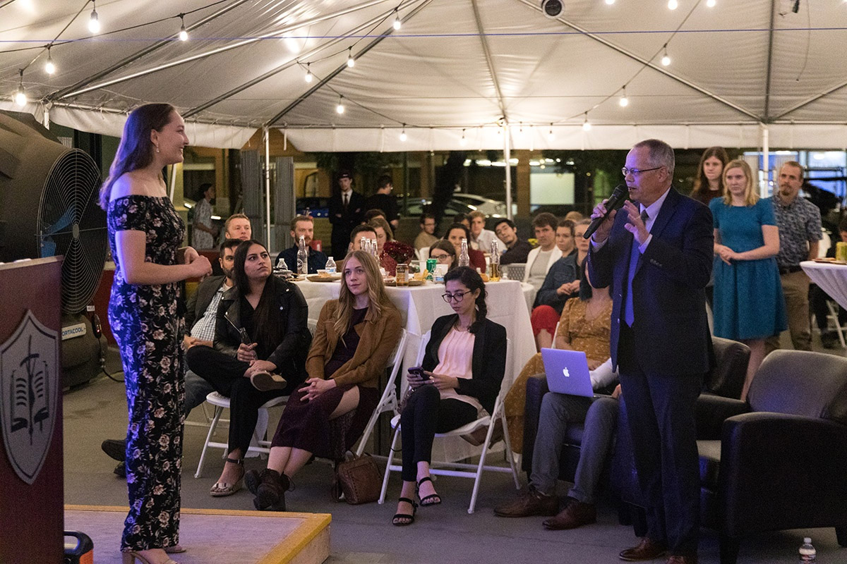 Prof. Jeff Deverett gives feedback to Bella Lake on her pitch