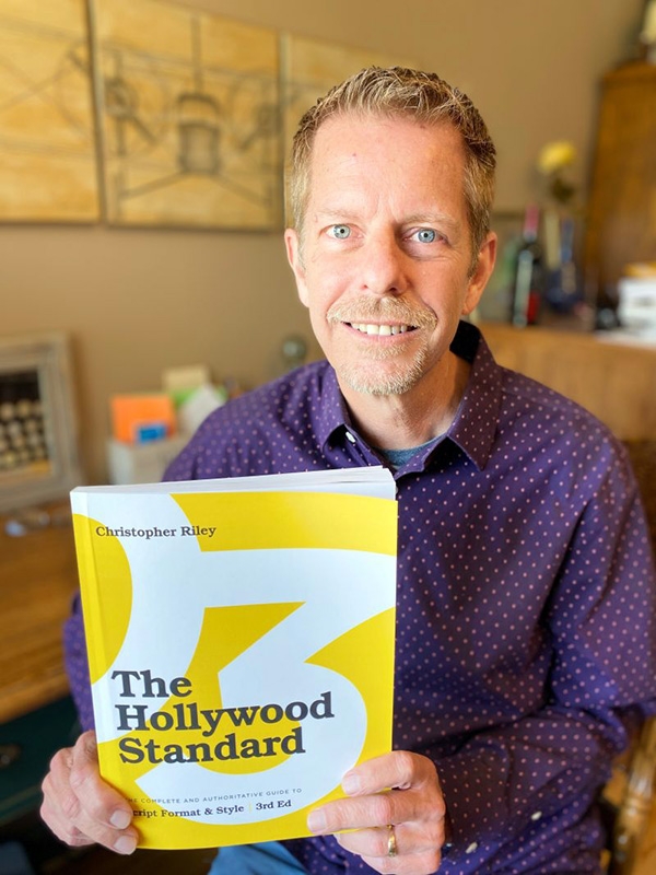 Prof. Chris Riley holding 3rd Edition of The Hollywood Standard