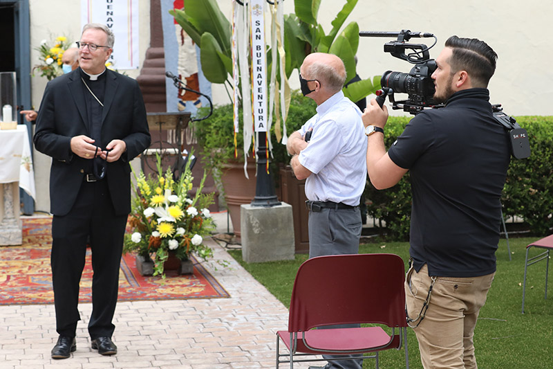 Douglas Cummins filming Bishop Robert Barron