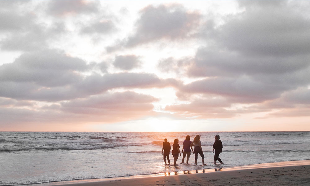Five Students at a Beach During Sunset